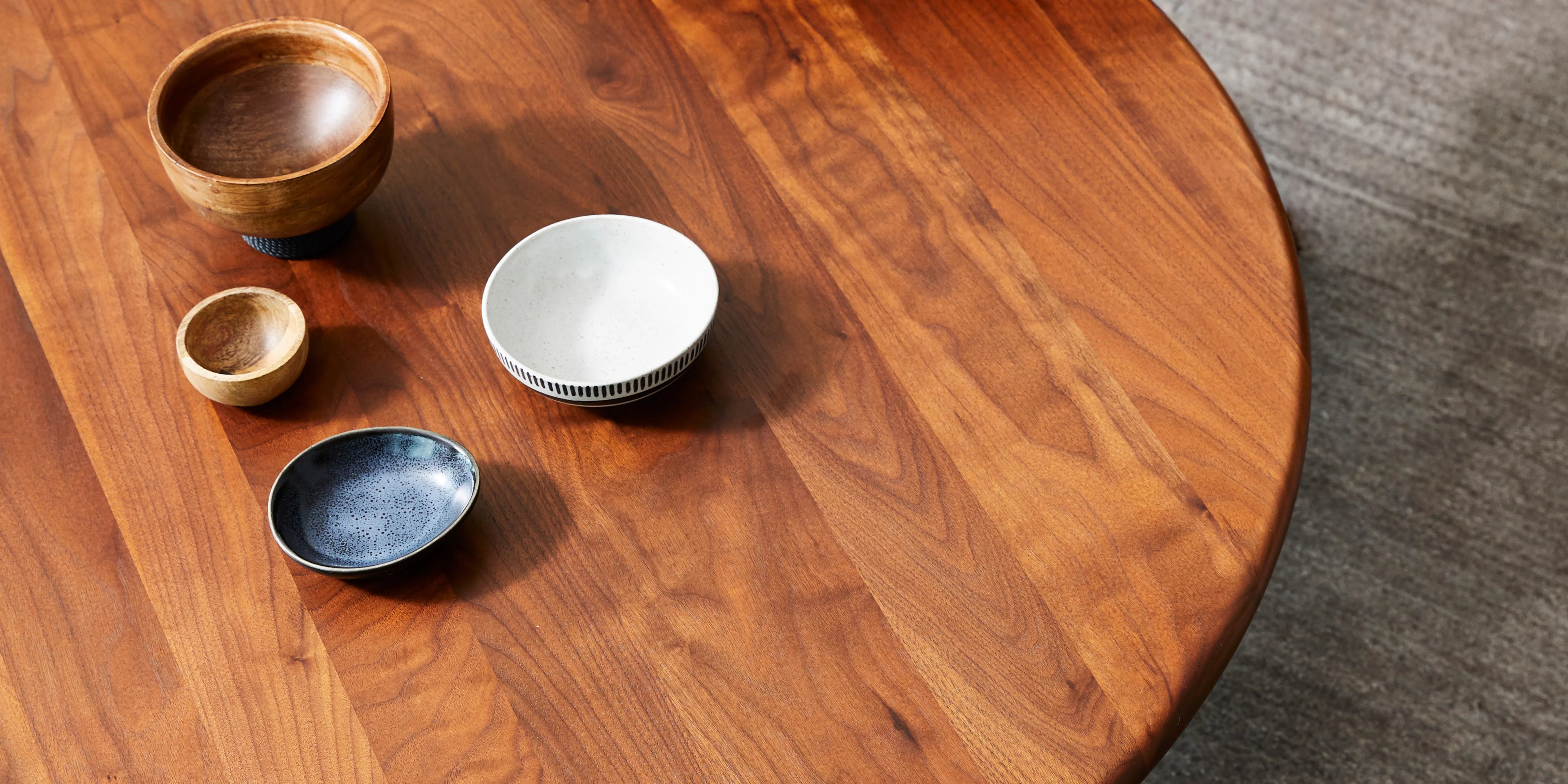 Walnut round dining table by IconByDesign