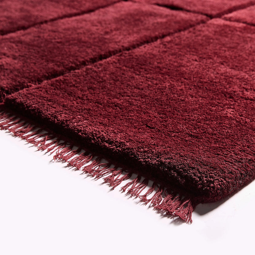 iconbydesign-tegel-nz-wool-rug-berry-red--SHARED--studio-a_detail-corner.webp